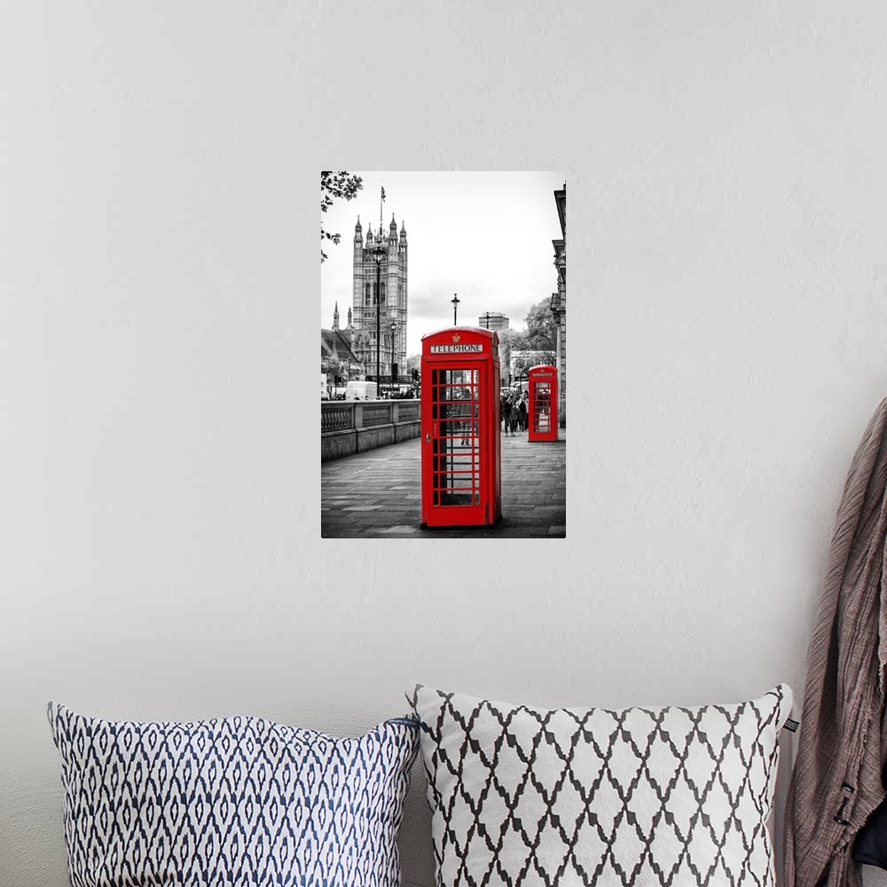 A bohemian room featuring Two red phone booths with the House of Parliament in the background, with selective coloring.