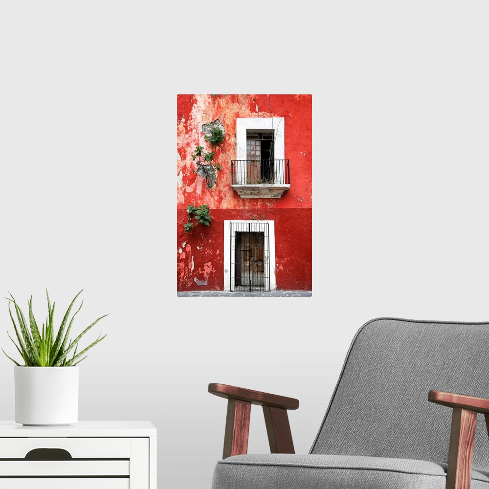 A modern room featuring Photograph of a rustic red wall in Mexico with peeling paint, a balcony, door, and plants growing...