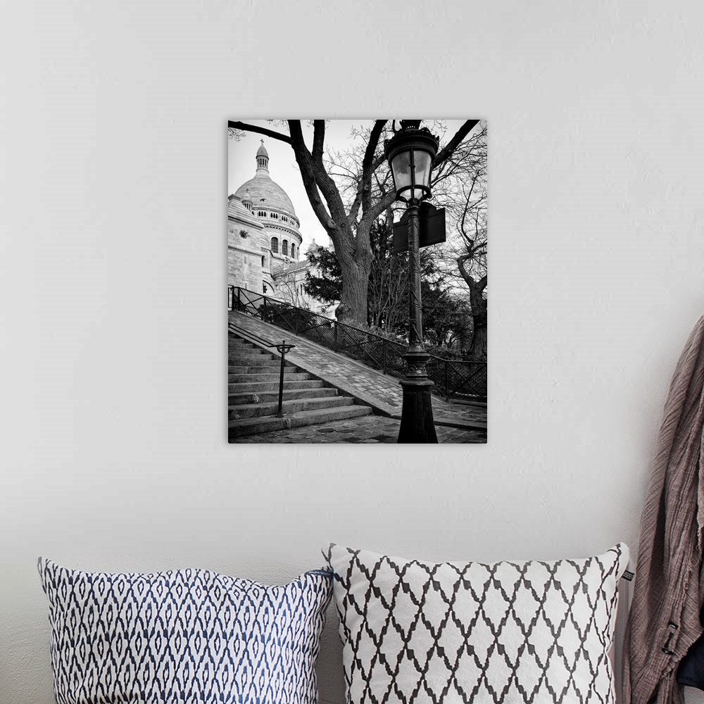 A bohemian room featuring A lamppost and stairway leading up to Sacre Coeur in France.