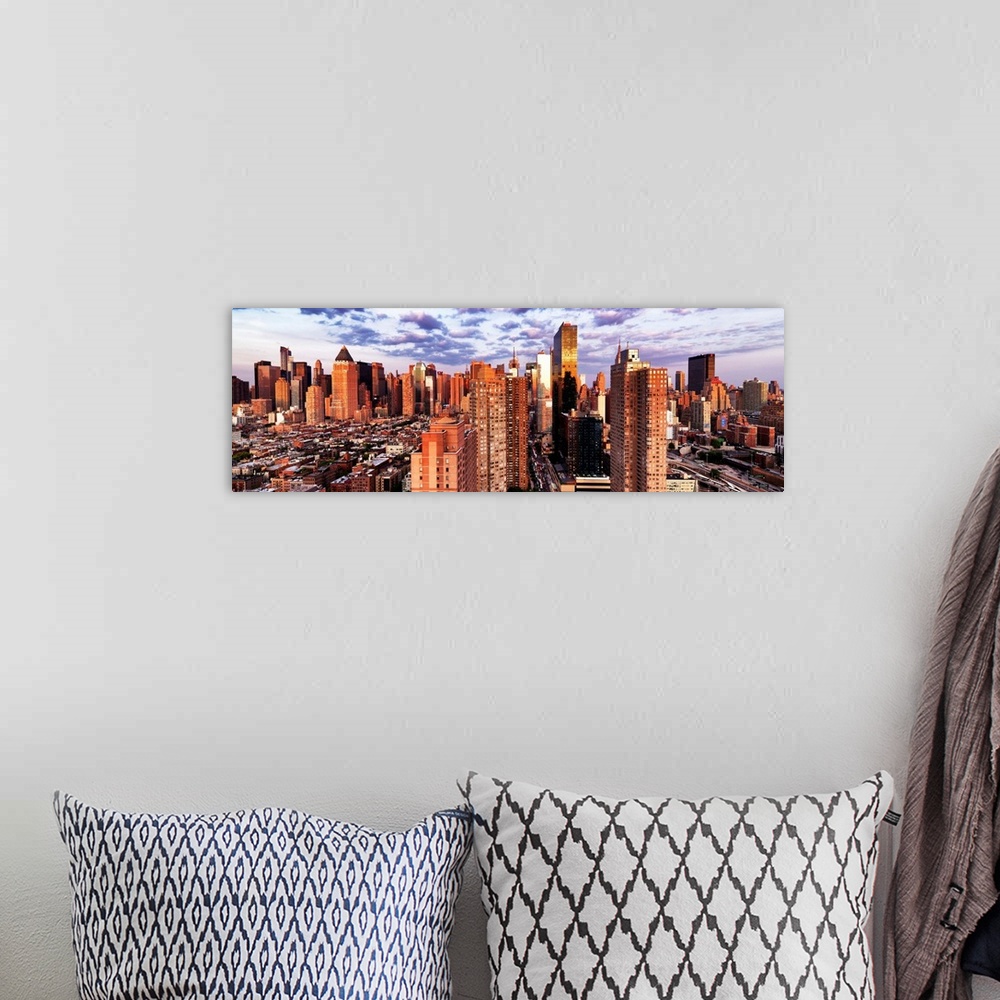 A bohemian room featuring Sunlight at dusk shining on the skyscrapers in New York City.