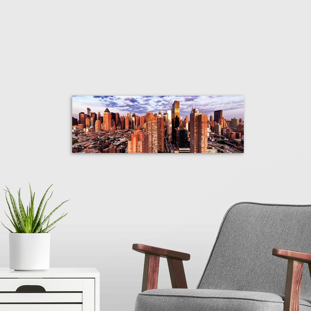 A modern room featuring Sunlight at dusk shining on the skyscrapers in New York City.