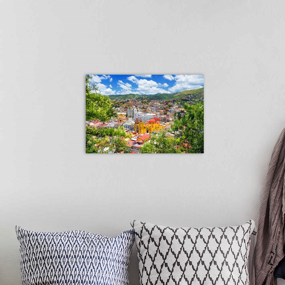 A bohemian room featuring Aerial photograph of a colorful cityscape in Guanajuato, mexico, framed by lush, green trees. Fro...
