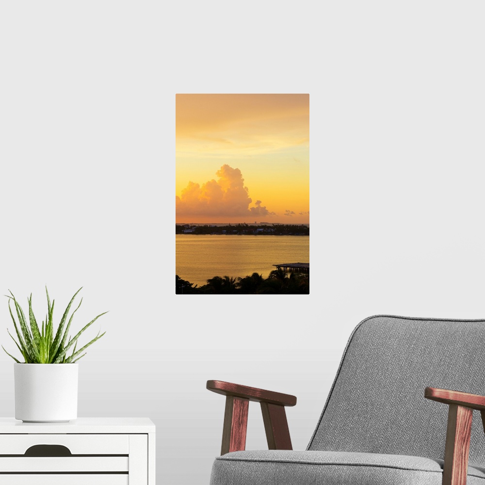 A modern room featuring Photograph of a beautiful orange, pink, and yellow sunset over Cancun, Mexico. From the Viva Mexi...