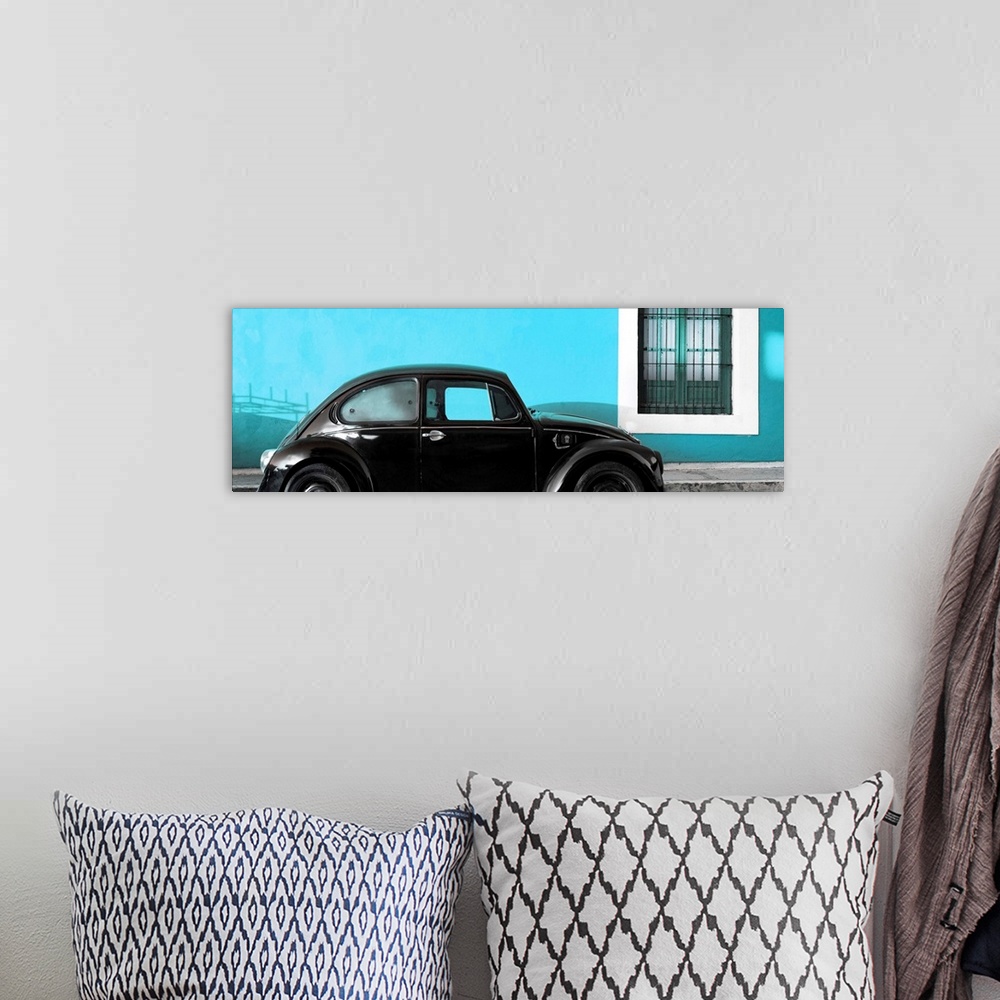 A bohemian room featuring Panoramic photograph of a classic black Volkswagen Beetle parked in front of a bright turquoise w...