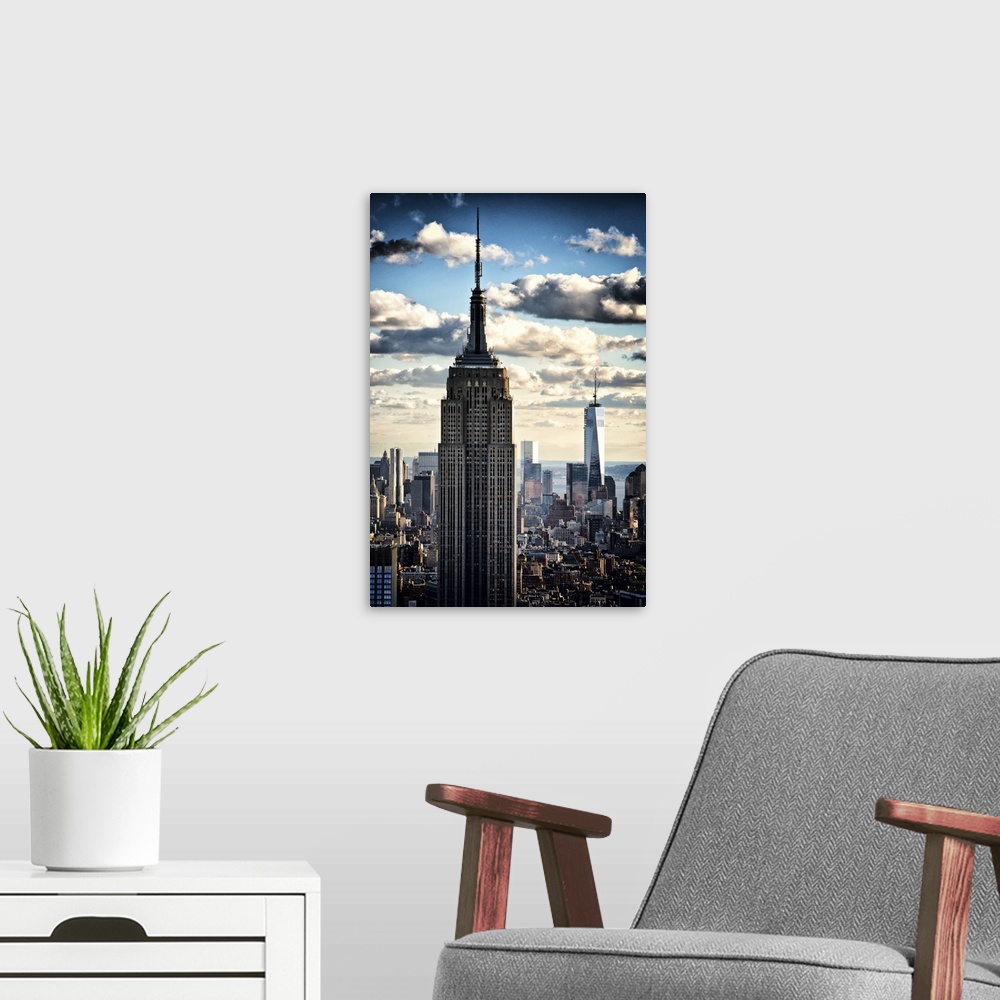 A modern room featuring Two skyscrapers towering over the New York City skyline under dramatic clouds.