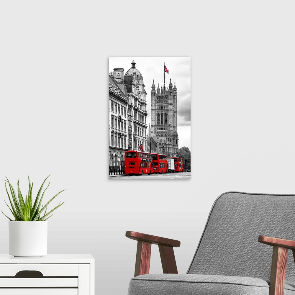A modern room featuring Row of double decker buses on the street by the House of Parliament in London, England.