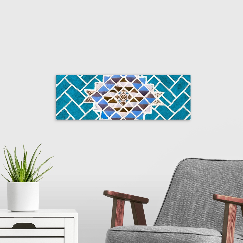 A modern room featuring Panoramic photograph of talavera tiles placed together on a wall to create a mosaic design surrou...