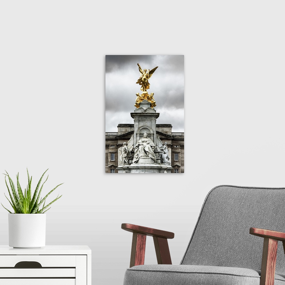 A modern room featuring View of the golden statue at the top of the Victoria Memorial under a cloudy sky.