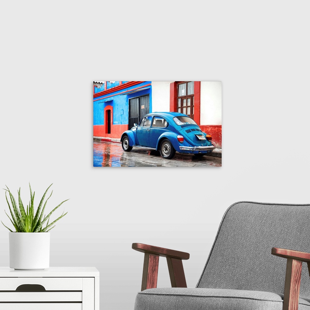 A modern room featuring Photograph of a classic blue Volkswagen Beetle parked in front of a blue and red building. From t...