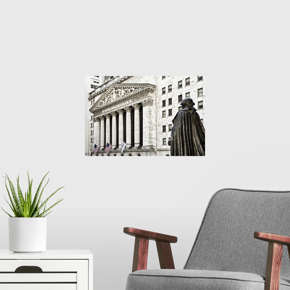 A modern room featuring Statue in front of the New York Stock Exchange building on Wall Street.