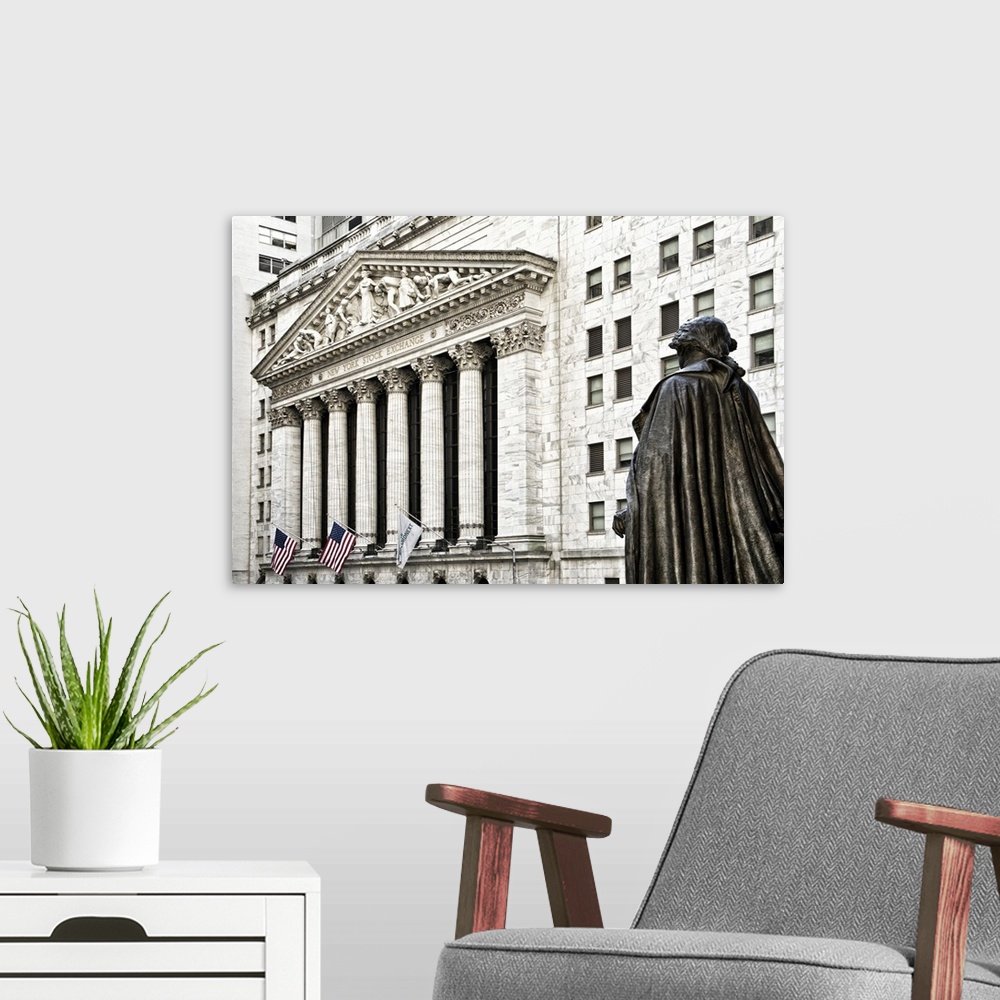 A modern room featuring Statue in front of the New York Stock Exchange building on Wall Street.