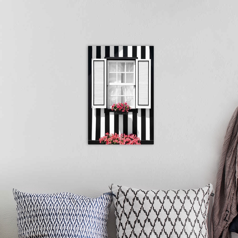 A bohemian room featuring Its' a window of a typical house with black and white stripes at Costa Nova Beach, Portugal.