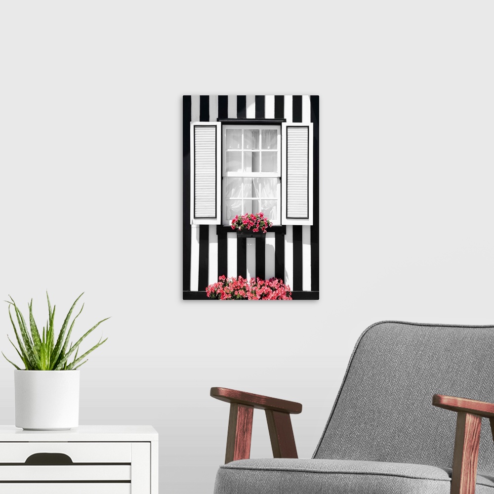A modern room featuring Its' a window of a typical house with black and white stripes at Costa Nova Beach, Portugal.