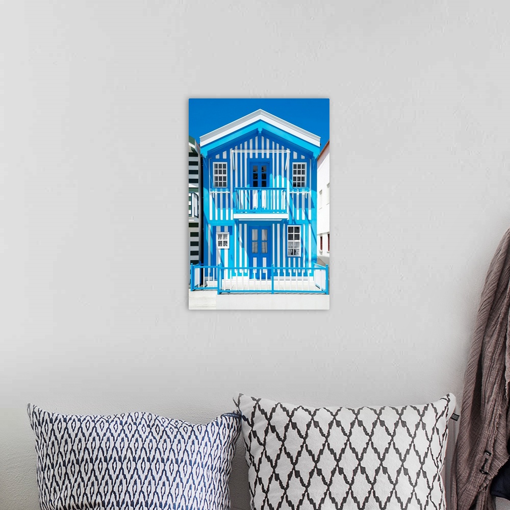 A bohemian room featuring Its' a typical house with blue stripes in Costa Nova Beach, Portugal.