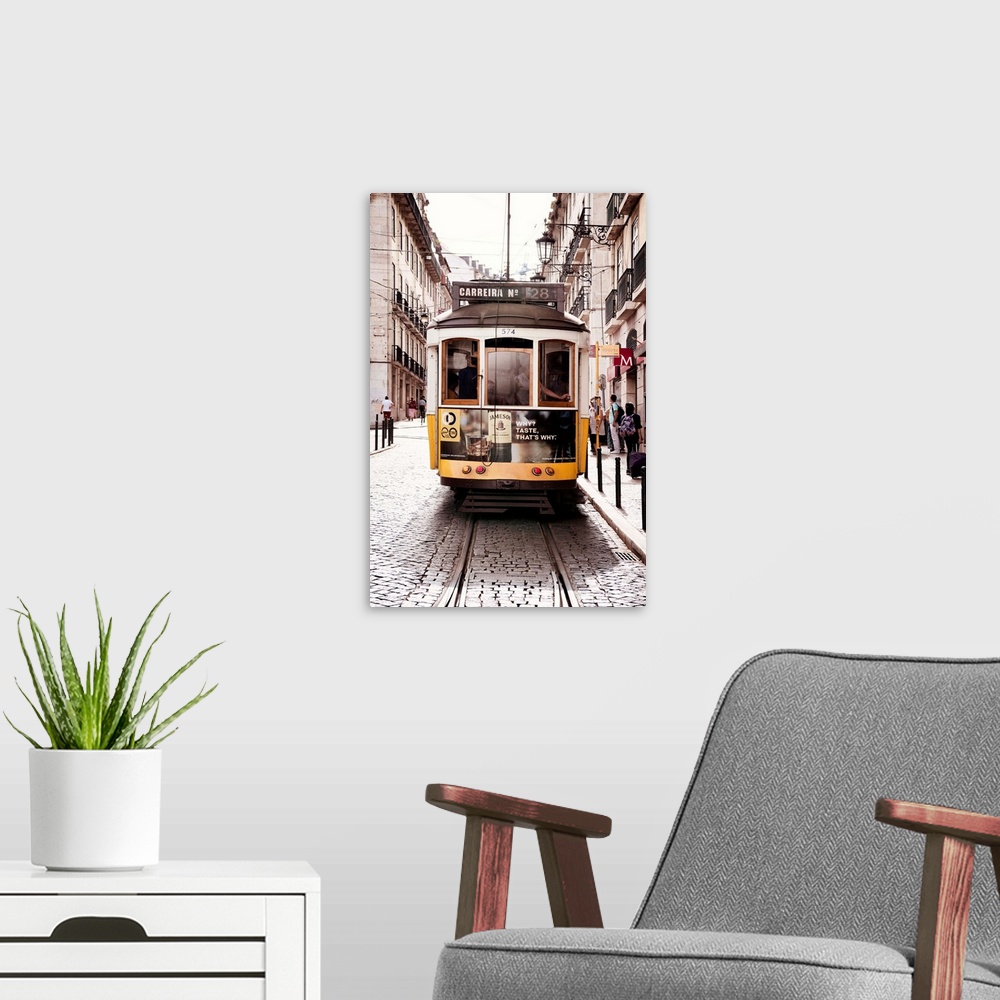 A modern room featuring This is the famous old yellow tramway 28 in the streets of lisbon in Portugal.