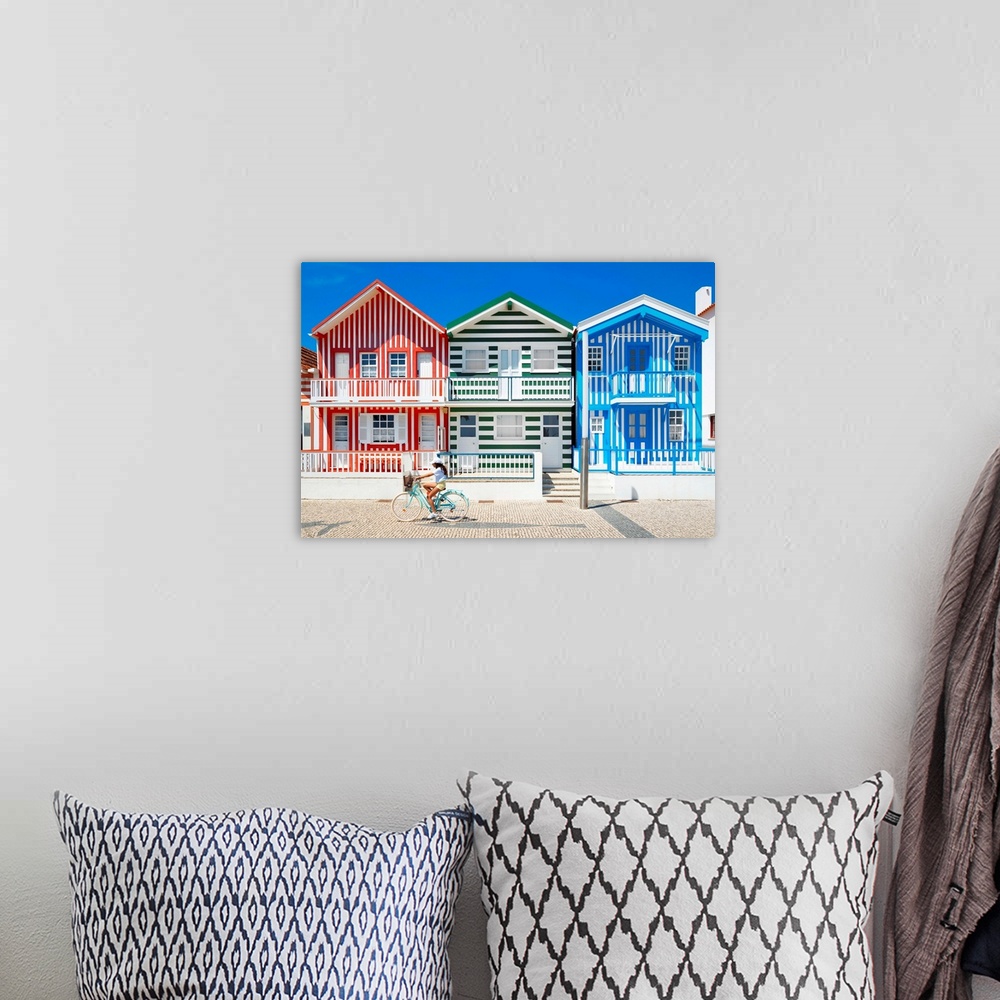 A bohemian room featuring These are three facades of colorful houses with stripes with a cyclist in turquoise bike in Costa...