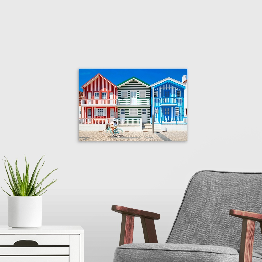 A modern room featuring These are three facades of colorful houses with stripes with a cyclist in turquoise bike in Costa...