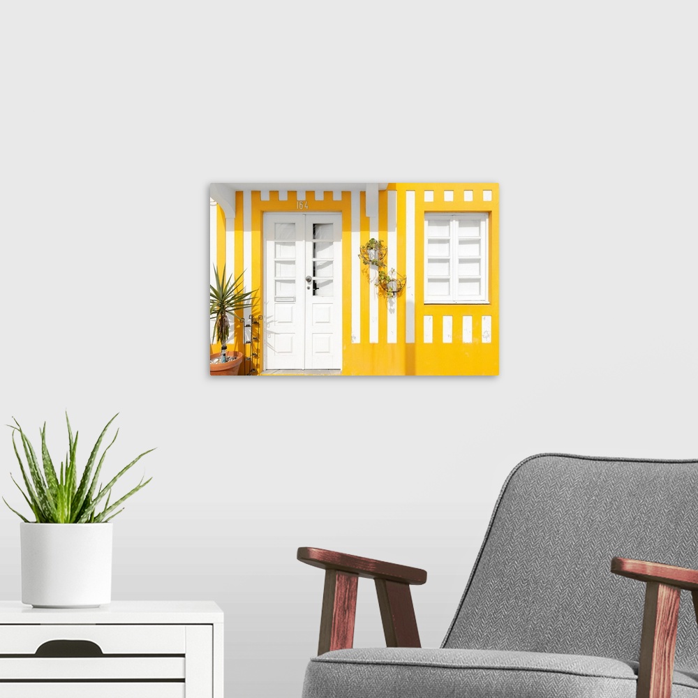 A modern room featuring It's a facade with yellow stripes of traditional house in costa Nova beach in Portugal.