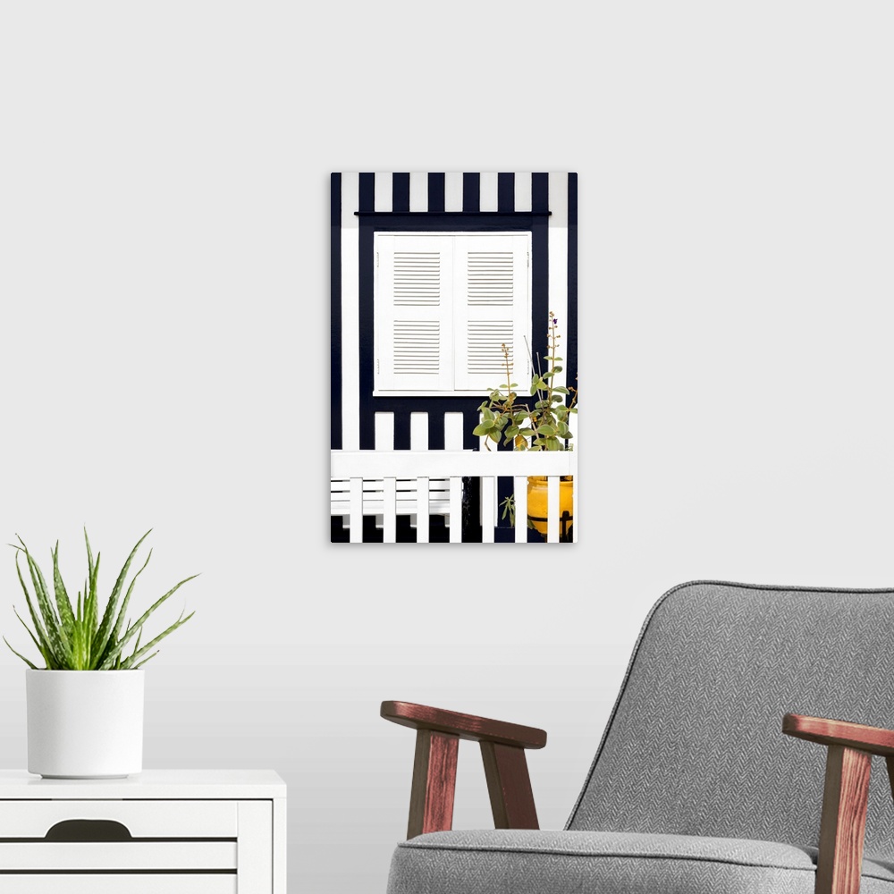 A modern room featuring It's a white window and a bench with navy blue stripes of a house facade at Costa Nova Beach in P...