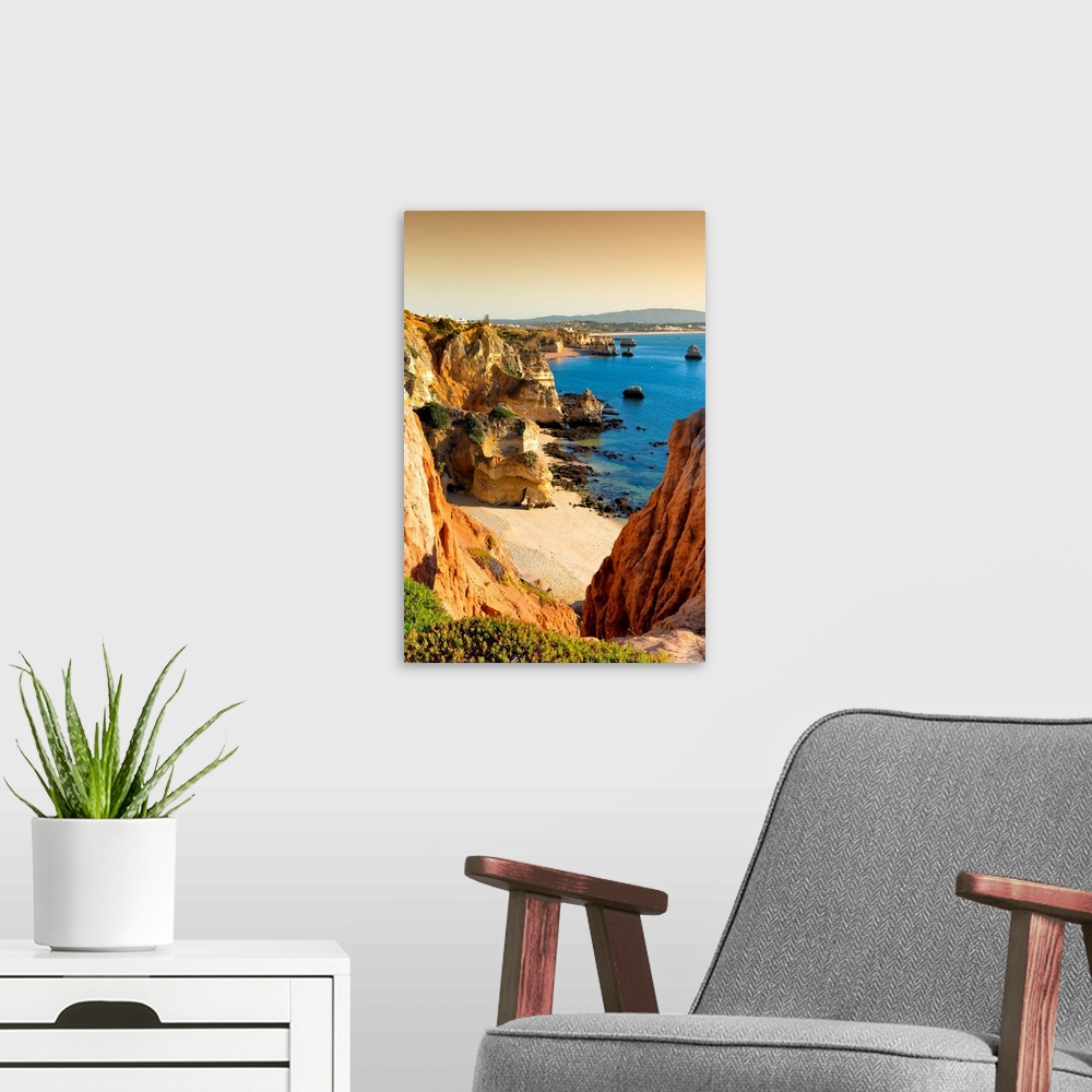 A modern room featuring It's a view at sunset of Lagos beach (Praia do Camillo) and orange cliffs in Portugal.