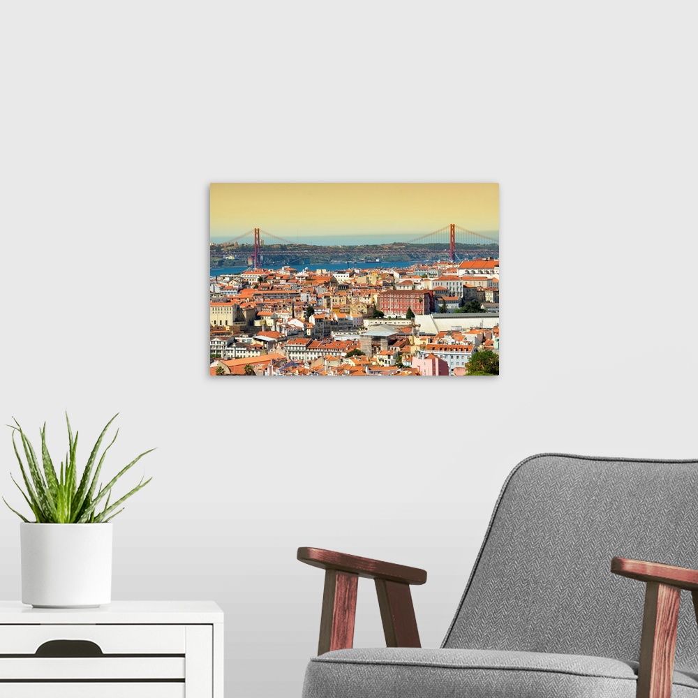 A modern room featuring It's a view of the city of Lisbon at sunset with the 25 de Abril bridge in Portugal.