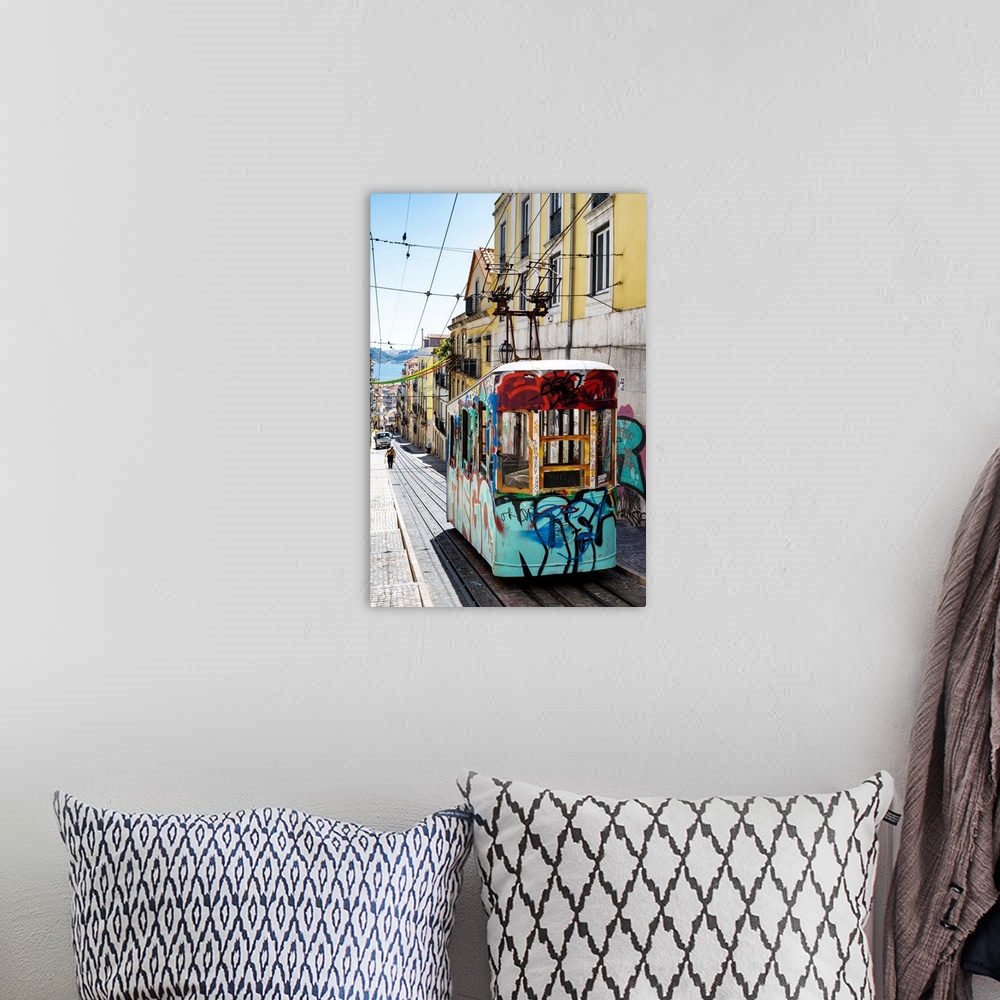 A bohemian room featuring It's the funicular of Bica with graffiti in the street Da Bica in Lisbon with colourful facades i...