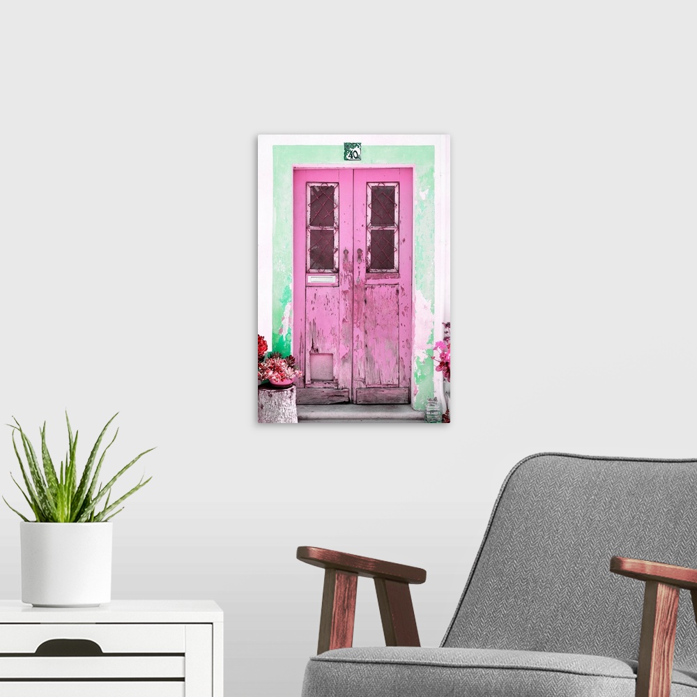 A modern room featuring It's an old pink door entrance to a traditional house in Portugal.