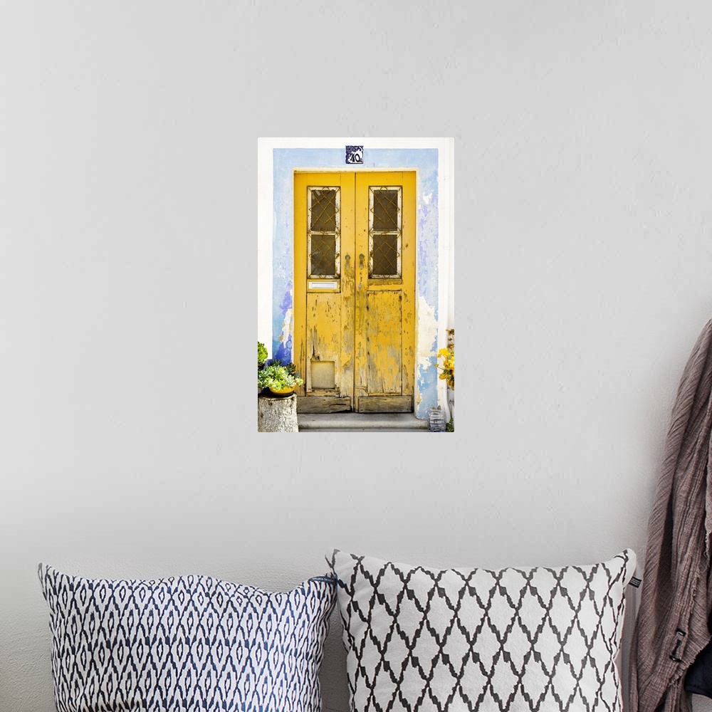 A bohemian room featuring It's an old yellow door entrance to a traditional house in Portugal.