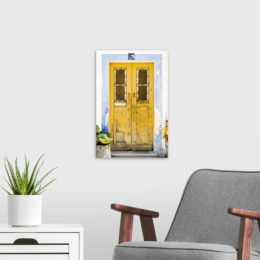 A modern room featuring It's an old yellow door entrance to a traditional house in Portugal.