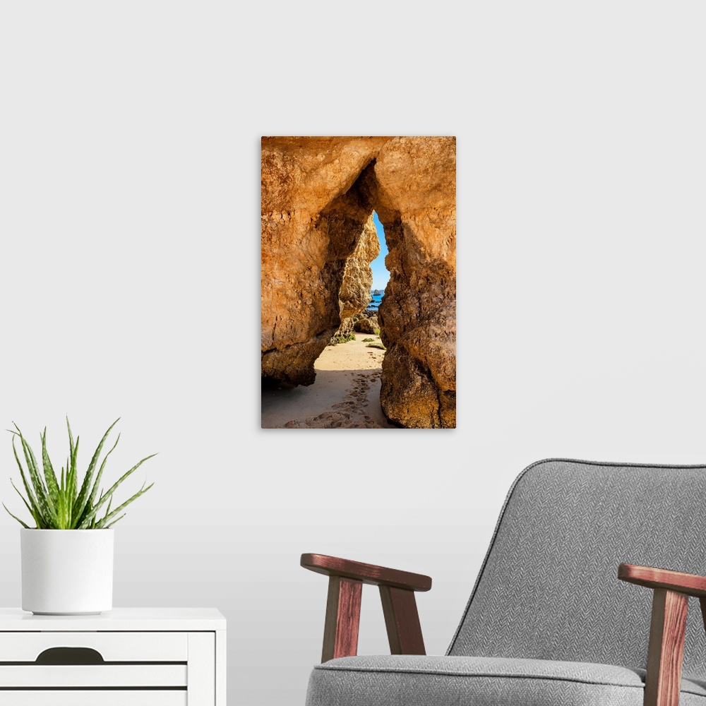 A modern room featuring It's a natural passage in a rock cliff on the beach of Praia do Camillo in Lagos (Portugal).