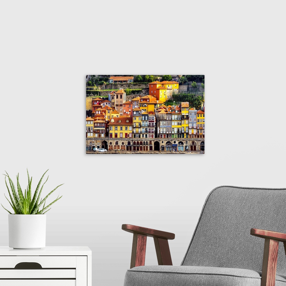 A modern room featuring This is a view of the Ribeira district in Porto on the banks of the Douro river at sunset with th...