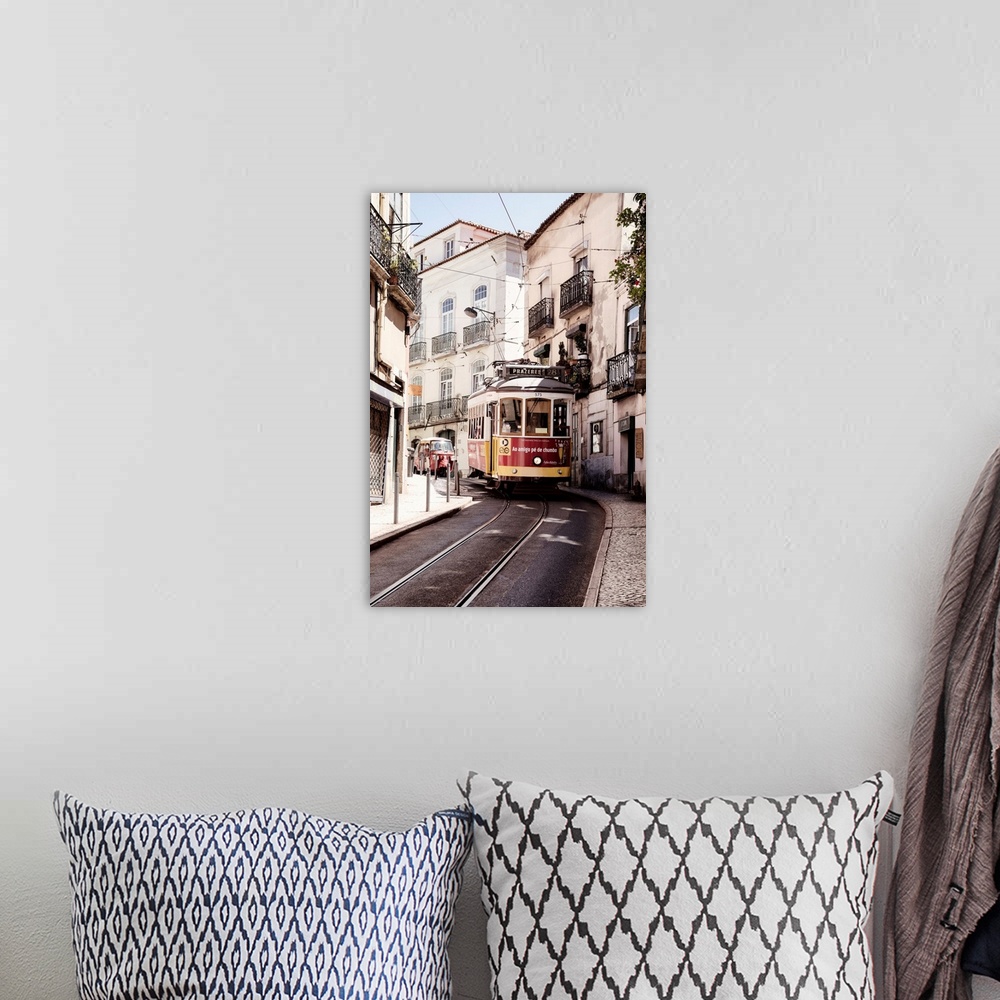 A bohemian room featuring This is the famous old yellow tramway 28 in the streets of lisbon in Portugal.