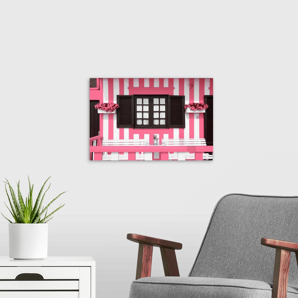 A modern room featuring It's a facade with pink stripes of traditional house in costa Nova beach in Portugal.