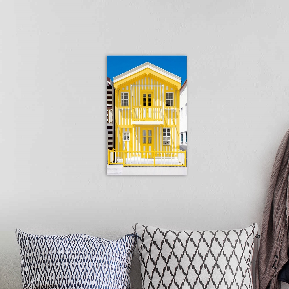 A bohemian room featuring Its' a typical house with yellow stripes in Costa Nova Beach, Portugal.