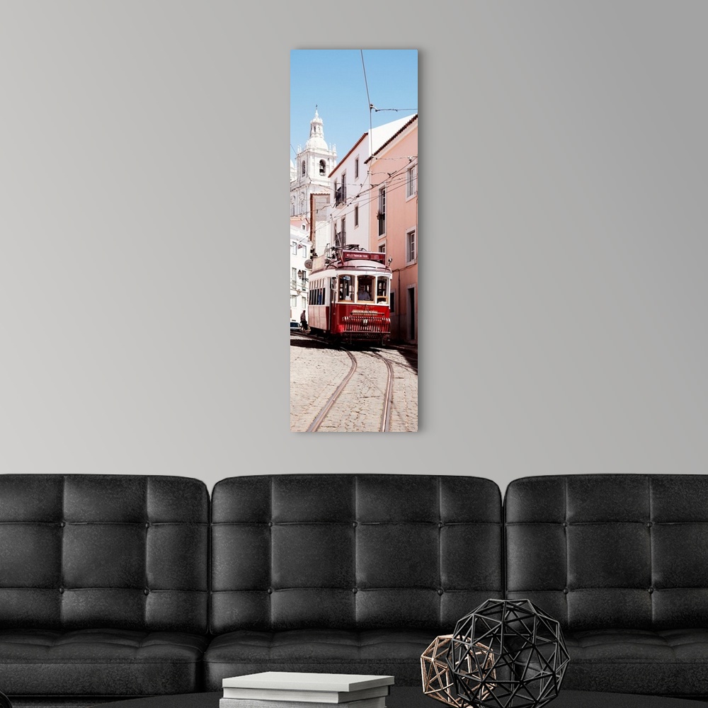 A modern room featuring It's a typical Lisbon street with a church and colorful Facades and the red tram in Portugal.
