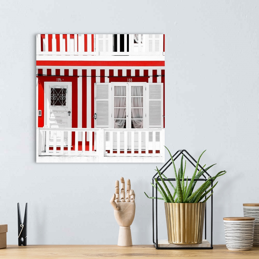 A bohemian room featuring It's a typical white house facade with red stripes in Costa Nova Beach, Portugal.