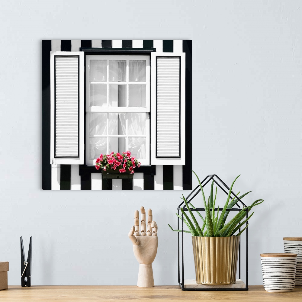 A bohemian room featuring It's a window of a typical house with black and white stripes at Costa Nova Beach, Portugal.
