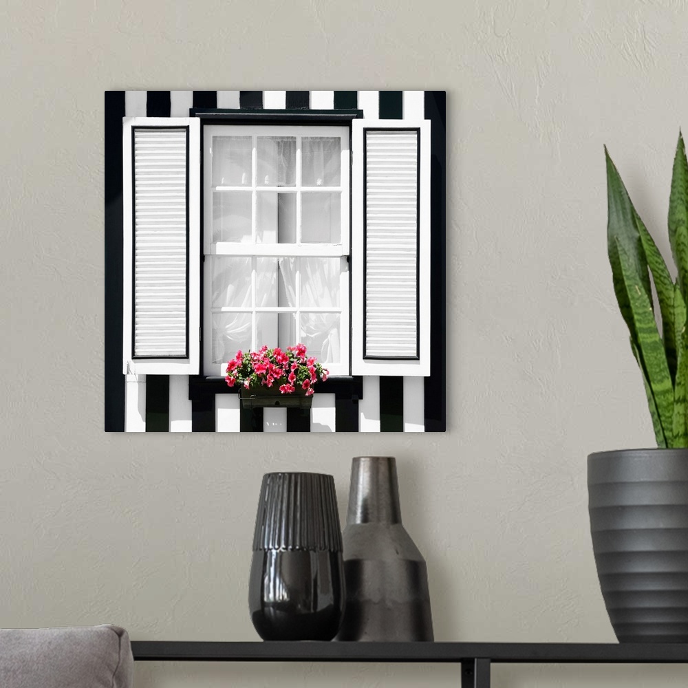 A modern room featuring It's a window of a typical house with black and white stripes at Costa Nova Beach, Portugal.