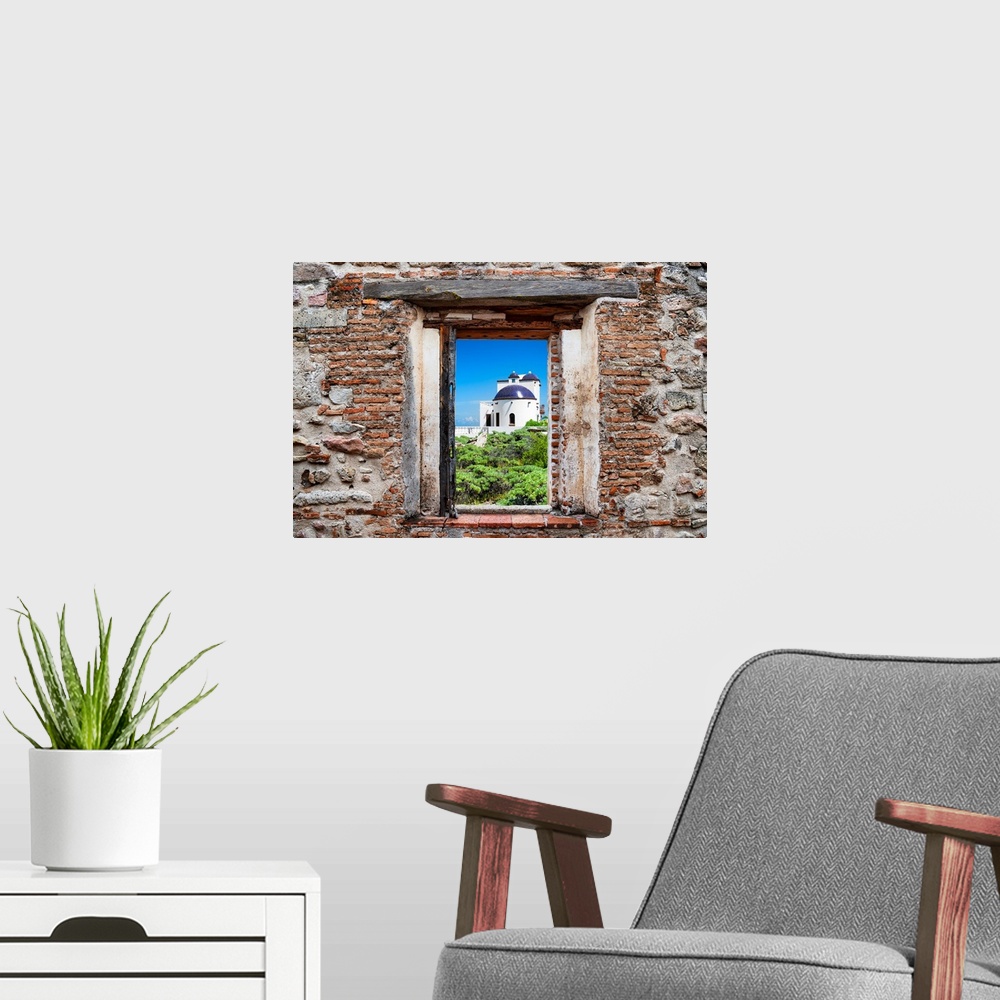 A modern room featuring View of a white house in Isla Mujeres, Mexico, framed through a stony, brick window. From the Viv...