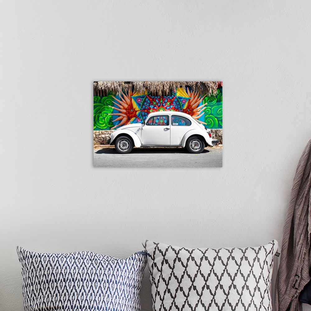 A bohemian room featuring Photograph of a classic white Volkswagen Beetle parked in front of a wall covered in colorful gra...
