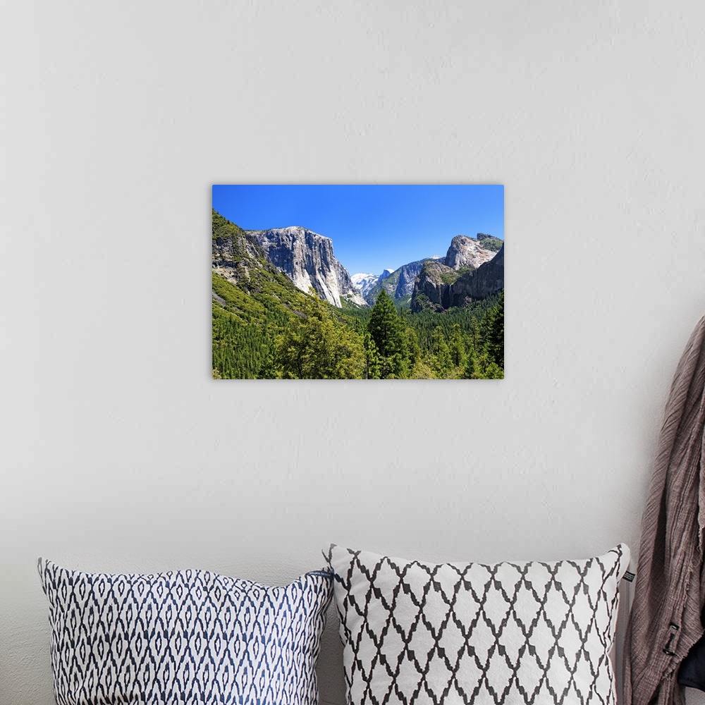 A bohemian room featuring The majestic peaks of Half Dome and its neighboring mountains over the forests of Yosemite Nation...