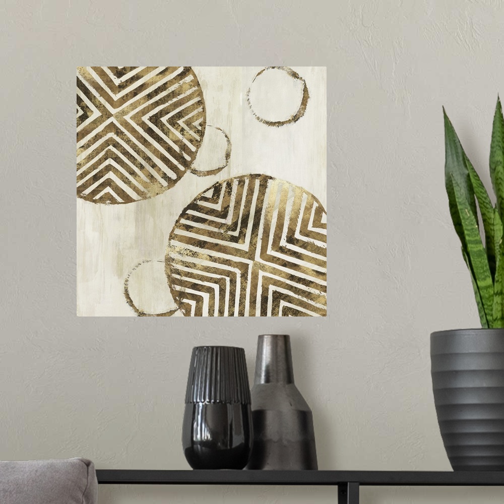 A modern room featuring Abstract art with metallic gold geometric circular shapes with lined designs on a light gold and ...