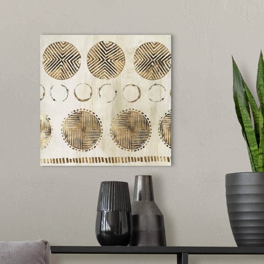 A modern room featuring Abstract art with metallic gold geometric circular shapes with lined designs on a light gold and ...