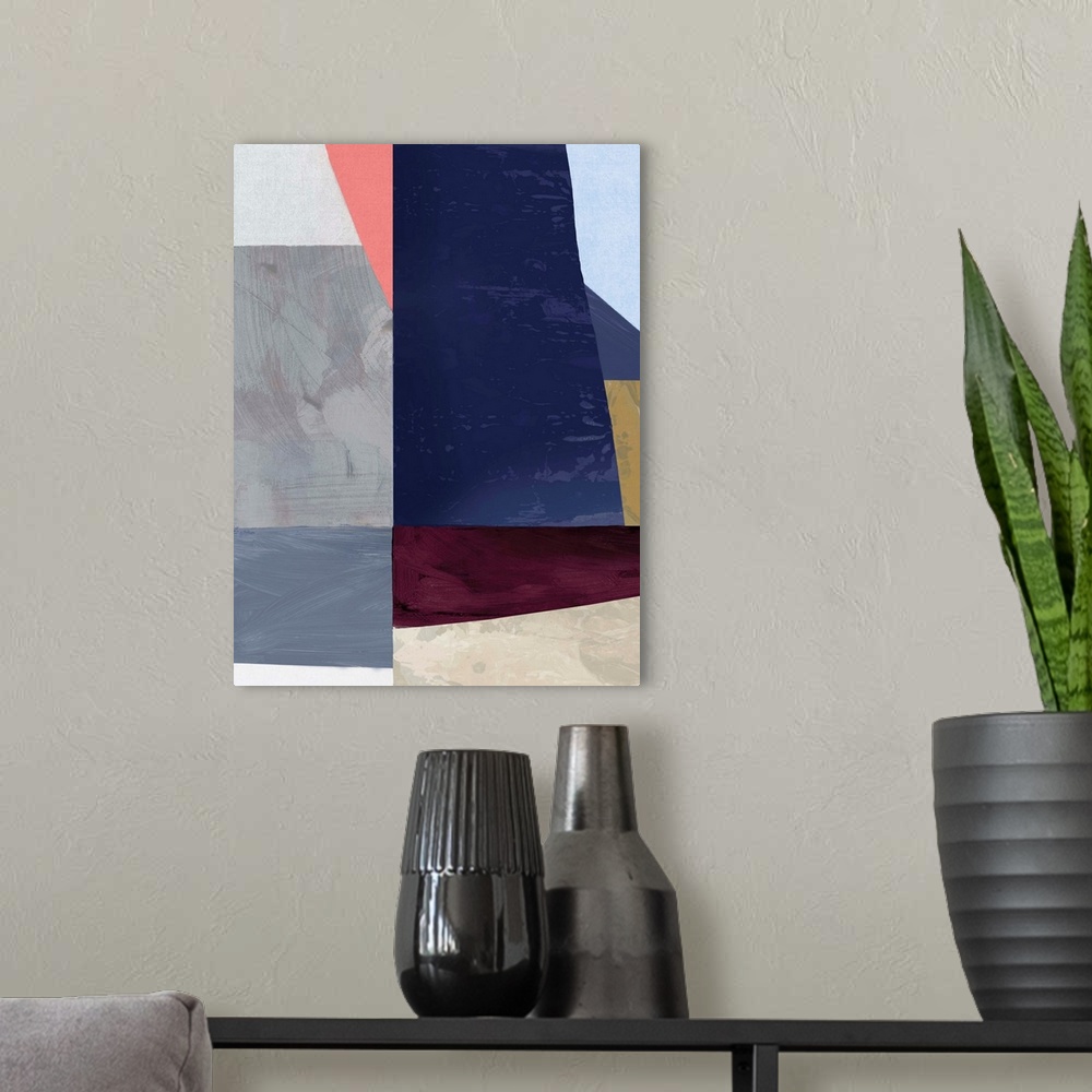 A modern room featuring Color block abstract artwork with shades of navy blue and coral pink.