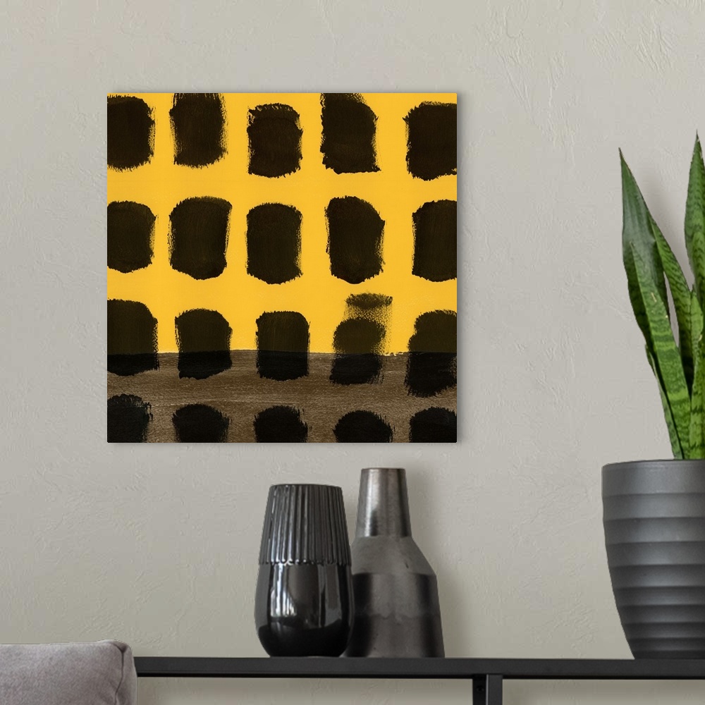 A modern room featuring Abstract art uses black squares to contrast the simple yellow background.