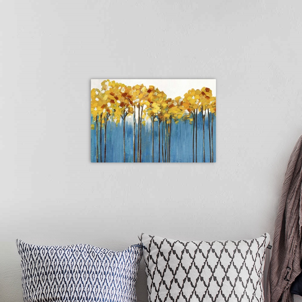 A bohemian room featuring Contemporary painting of a row of slender trees with amber leaves over periwinkle blue.