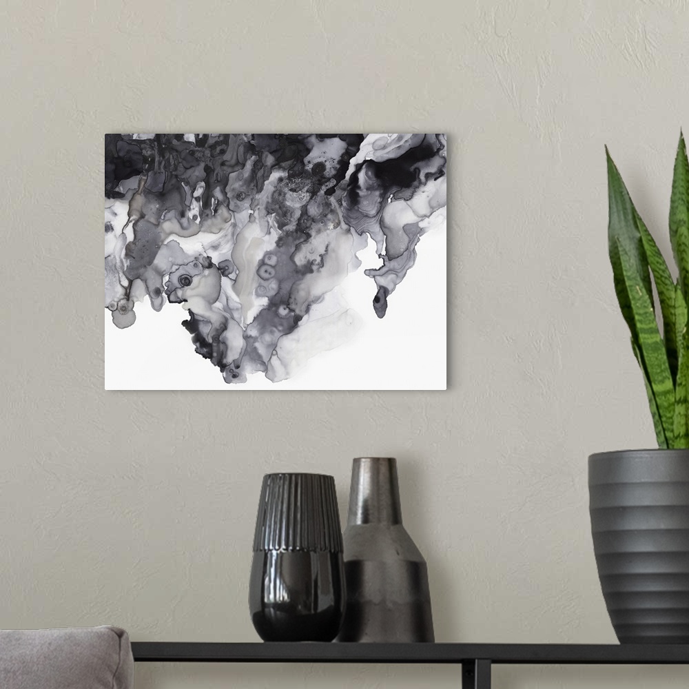 A modern room featuring Abstract artwork with different textured shades of gray on a white background.