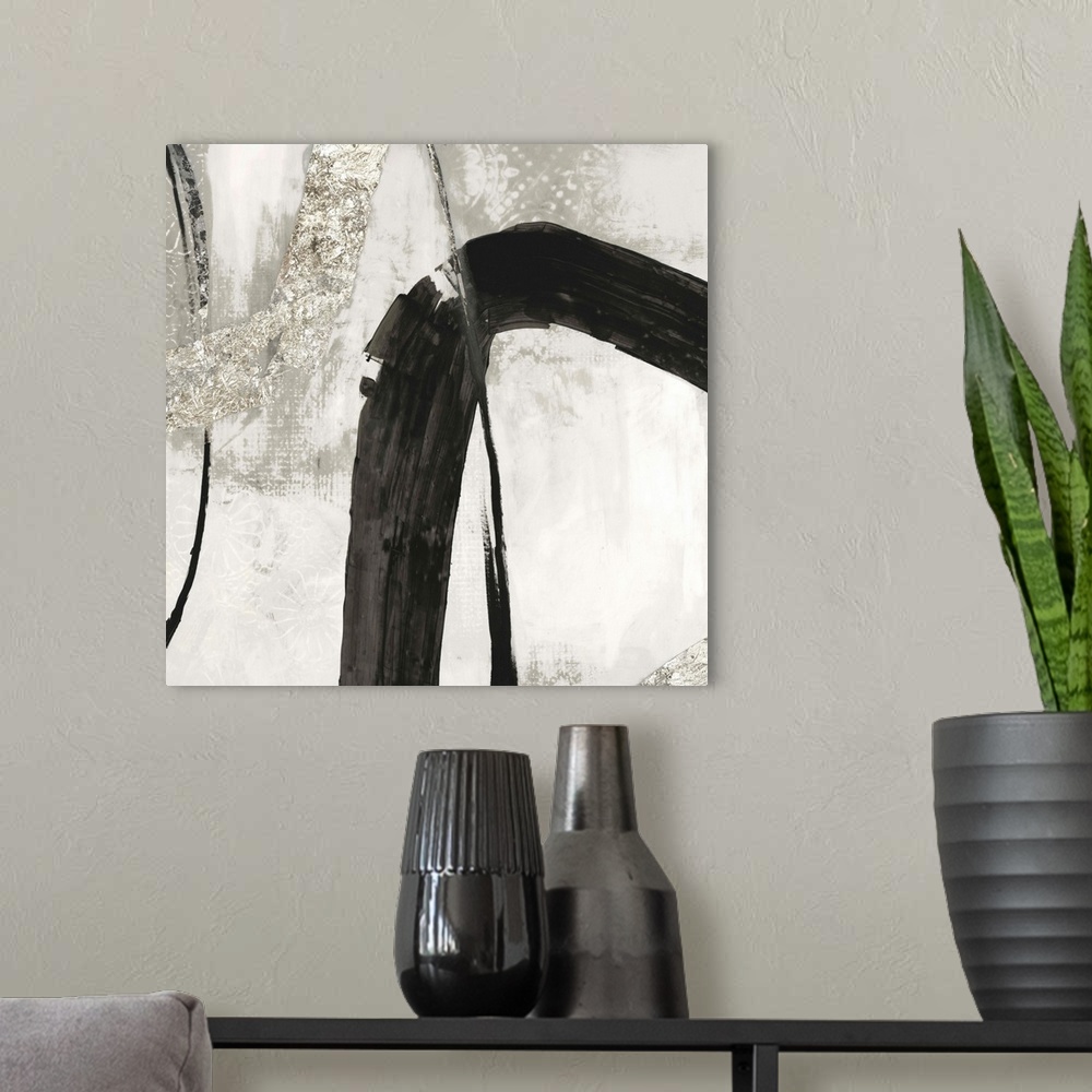 A modern room featuring Silver abstract artwork intersected by a black streak.