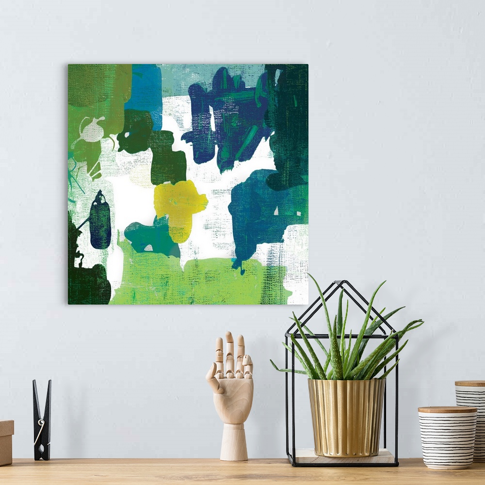 A bohemian room featuring A contemporary painting of abstract shapes in varies shades of green.