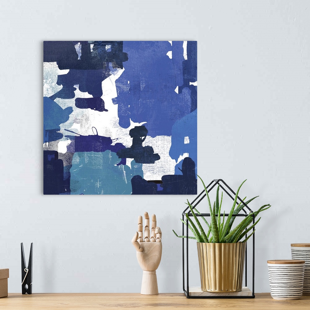 A bohemian room featuring A contemporary painting of abstract shapes in varies shades of blue.